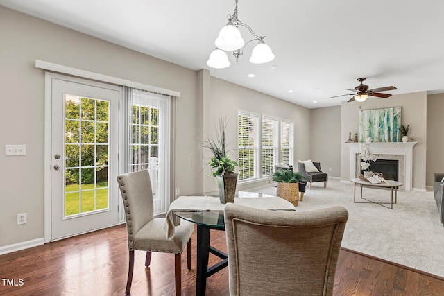 1201 Woodlands Creek Way, Apex, NC 27502 - dining room with plenty of natural light, wood finished floors, a chandelier, a fireplace, and recessed lighting