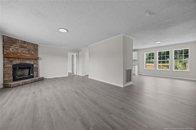 1271 Nutgrass Rd, Bunnlevel, NC 28323 - unfurnished living room featuring a textured ceiling, wood finished floors, and a stone fireplace