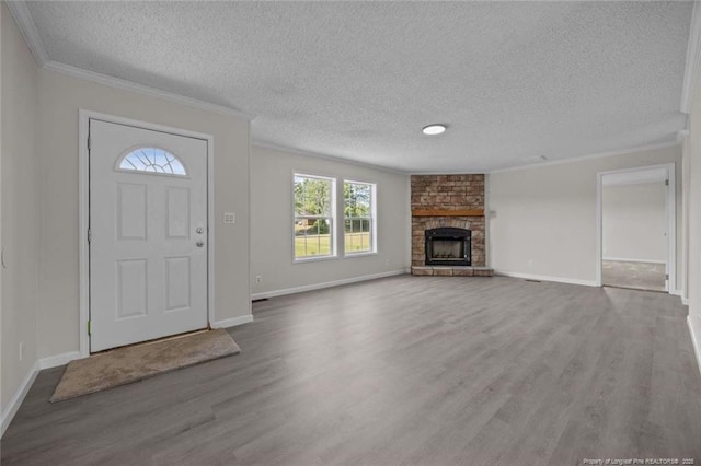 1271 Nutgrass Rd, Bunnlevel, NC 28323 - foyer entrance featuring wood finished floors, crown molding, a textured ceiling, and a large fireplace