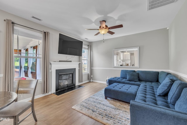 2714 Magnolia Tree Ln, Durham, NC 27703 - living room featuring wood finished floors, a glass covered fireplace, and ceiling fan