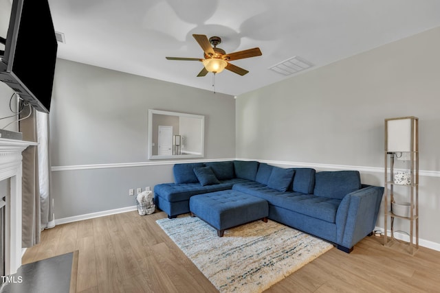 2714 Magnolia Tree Ln, Durham, NC 27703 - living area with a ceiling fan, wood finished floors, and a fireplace with flush hearth