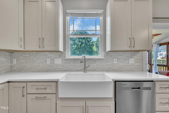 2714 Magnolia Tree Ln, Durham, NC 27703 - kitchen with stainless steel dishwasher, backsplash, light countertops, and plenty of natural light