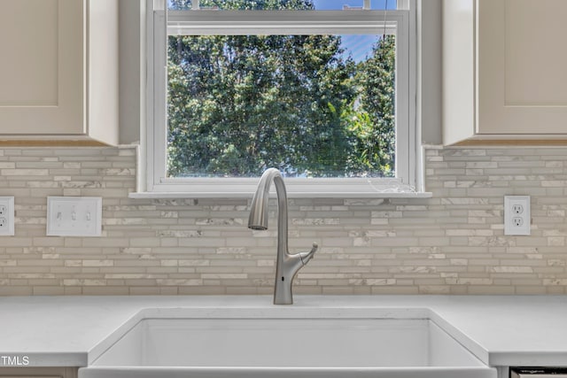 2714 Magnolia Tree Ln, Durham, NC 27703 - kitchen view of tasteful backsplash, light countertops, and white cabinetry