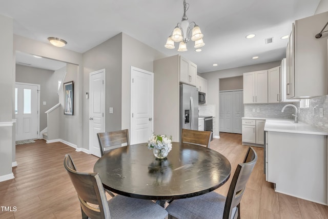 2714 Magnolia Tree Ln, Durham, NC 27703 - dining area with a chandelier, light wood-type flooring, and recessed lighting