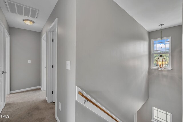 2714 Magnolia Tree Ln, Durham, NC 27703 - hallway featuring an upstairs landing, carpet floors, and a chandelier