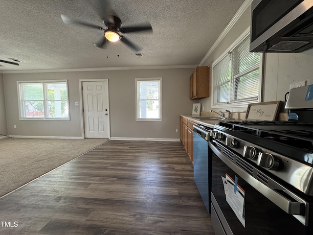 122 S 5th St, Spring Lake, NC 28390 - kitchen with stainless steel appliances, healthy amount of natural light, ornamental molding, a ceiling fan, and dark wood-type flooring