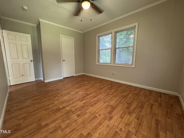 122 S 5th St, Spring Lake, NC 28390 - unfurnished bedroom with wood finished floors, a ceiling fan, ornamental molding, and a textured ceiling