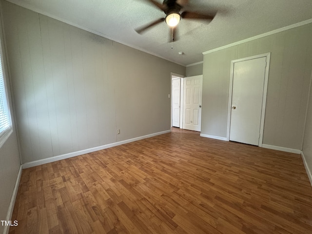 122 S 5th St, Spring Lake, NC 28390 - unfurnished bedroom with wood finished floors, a textured ceiling, crown molding, and ceiling fan