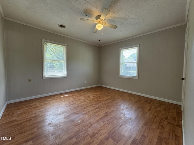 122 S 5th St, Spring Lake, NC 28390 - empty room with wood finished floors, ornamental molding, a ceiling fan, and a textured ceiling