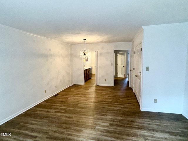 2535 Fairway Dr, Henderson, NC 27536 - empty room with dark wood finished floors, a chandelier, and ornamental molding