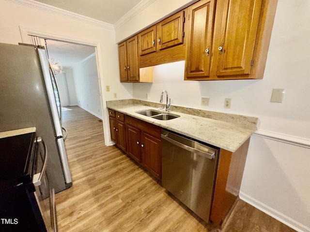 2535 Fairway Dr, Henderson, NC 27536 - kitchen featuring appliances with stainless steel finishes, light wood-style floors, ornamental molding, brown cabinetry, and light stone countertops