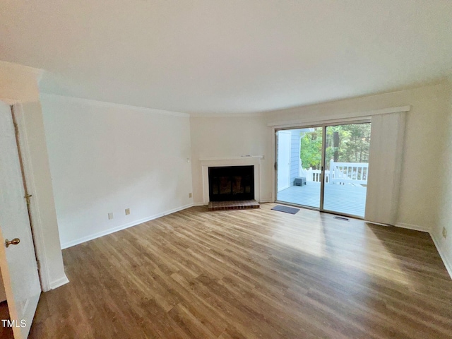 2535 Fairway Dr, Henderson, NC 27536 - unfurnished living room featuring wood finished floors and a brick fireplace