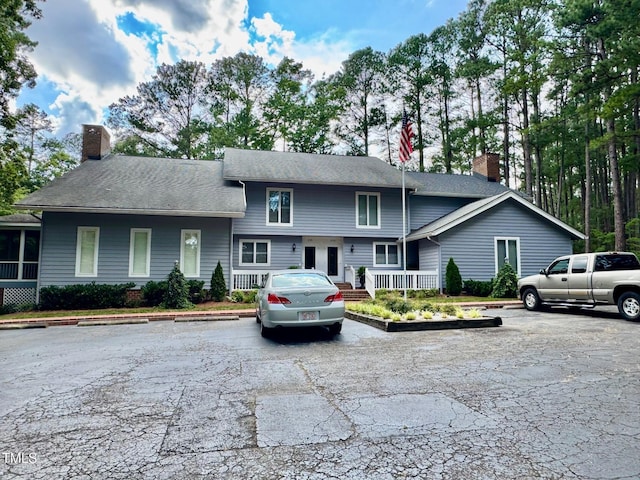 2535 Fairway Dr, Henderson, NC 27536 - view of front of house with a chimney and uncovered parking