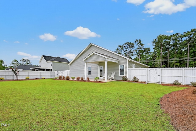 611 Laurel Lake Rd, Salemburg, NC 28385 - back of house featuring a fenced backyard, a gate, and a patio area