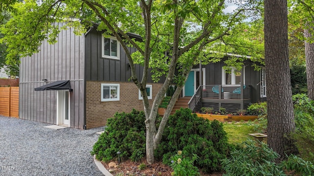 3033 Sylvania Dr, Raleigh, NC 27607 - view of front of property with brick siding, board and batten siding, stairway, and a deck