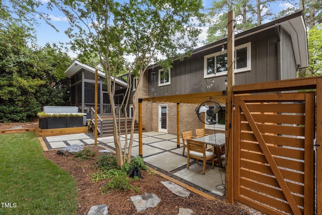 3033 Sylvania Dr, Raleigh, NC 27607 - back of house featuring a sunroom, a patio area, brick siding, and board and batten siding