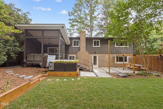 3033 Sylvania Dr, Raleigh, NC 27607 - rear view of property featuring a sunroom, a patio, brick siding, a chimney, and a ceiling fan