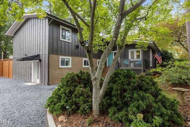 3033 Sylvania Dr, Raleigh, NC 27607 - view of side of property with brick siding and board and batten siding