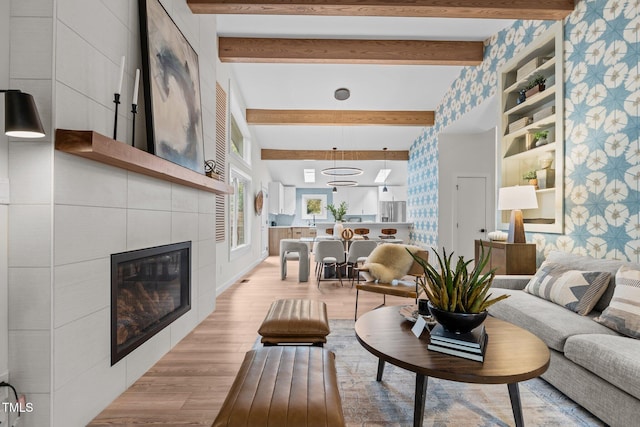3033 Sylvania Dr, Raleigh, NC 27607 - living room with light wood-style floors, beam ceiling, and a tile fireplace