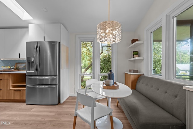 3033 Sylvania Dr, Raleigh, NC 27607 - dining space featuring healthy amount of natural light, light wood-type flooring, and a skylight