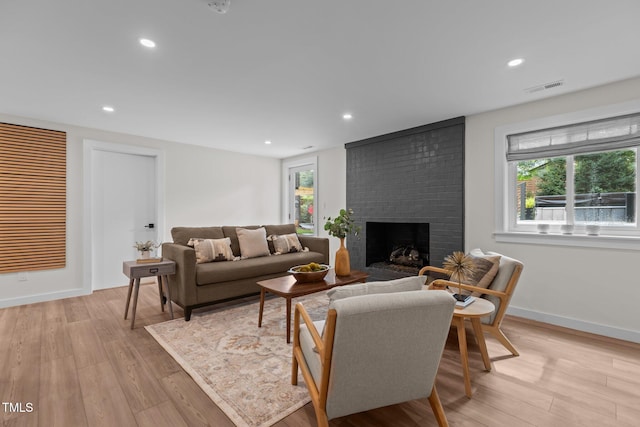 3033 Sylvania Dr, Raleigh, NC 27607 - living area with a fireplace, plenty of natural light, light wood-type flooring, and recessed lighting
