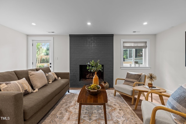 3033 Sylvania Dr, Raleigh, NC 27607 - living area with recessed lighting, a brick fireplace, and wood finished floors