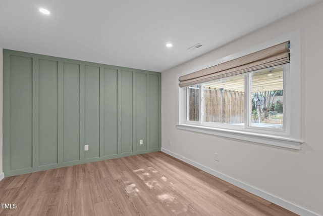 3033 Sylvania Dr, Raleigh, NC 27607 - unfurnished room featuring light wood-style floors, recessed lighting, and a decorative wall