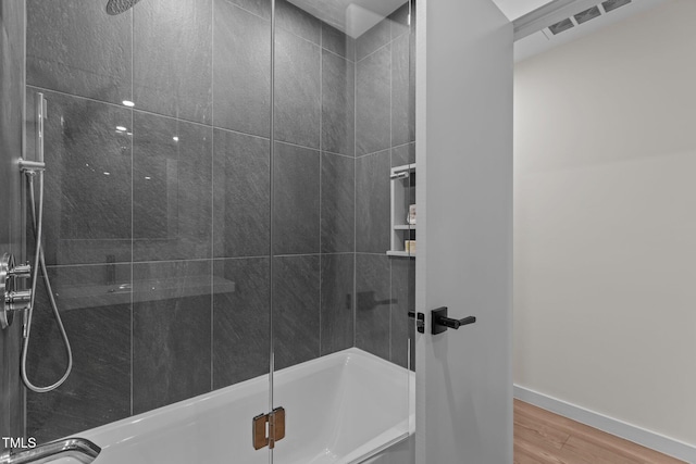 3033 Sylvania Dr, Raleigh, NC 27607 - bathroom featuring wood finished floors and enclosed tub / shower combo