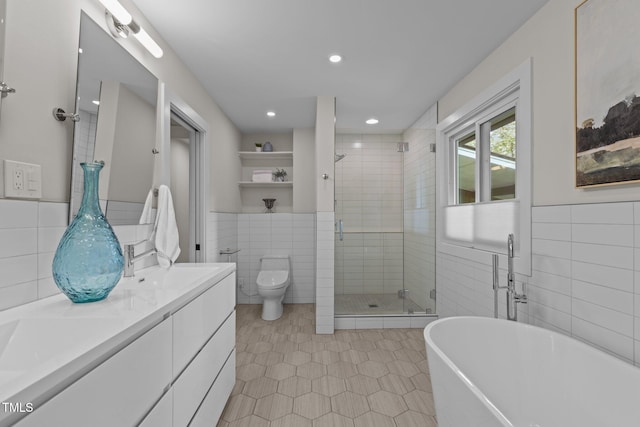 3033 Sylvania Dr, Raleigh, NC 27607 - full bath featuring tile walls, a shower stall, a freestanding tub, double vanity, and tile patterned floors