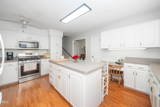 1312 Hampton Valley Rd, Cary, NC 27511 - kitchen with appliances with stainless steel finishes, light wood-style flooring, light countertops, and ceiling fan
