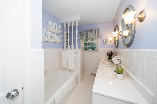 1312 Hampton Valley Rd, Cary, NC 27511 - full bath with double vanity, a garden tub, tile walls, and wainscoting