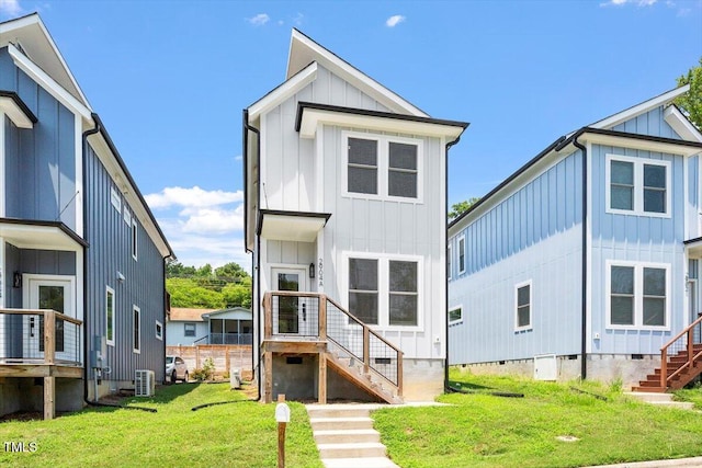 2904 Wadsworth Ave # A, Durham, NC 27707 - back of house with board and batten siding, crawl space, stairs, and a lawn