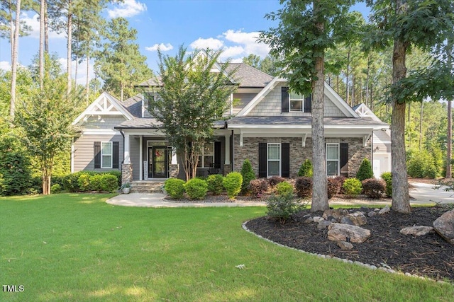 1203 Smith Creek Way, Wake Forest, NC 27587 - craftsman inspired home featuring a front lawn, stone siding, and a porch