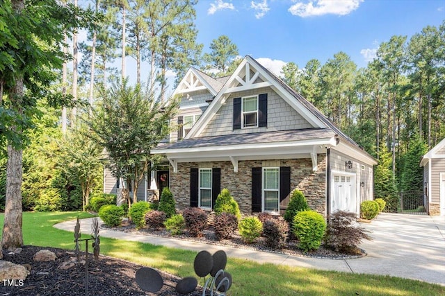1203 Smith Creek Way, Wake Forest, NC 27587 - craftsman-style house with driveway, a front yard, an attached garage, stone siding, and covered porch