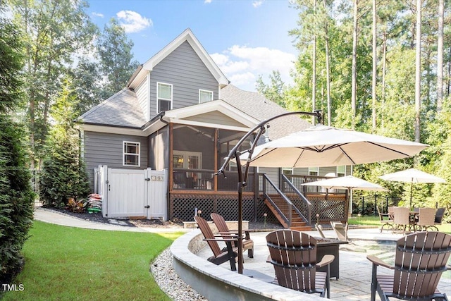 1203 Smith Creek Way, Wake Forest, NC 27587 - back of house featuring an outdoor fire pit, a sunroom, a patio, a gate, and a shingled roof