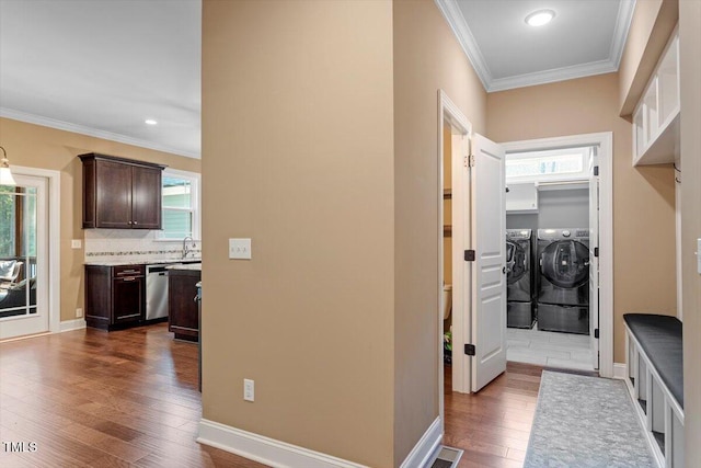 1203 Smith Creek Way, Wake Forest, NC 27587 - washroom with washing machine and dryer, ornamental molding, dark wood finished floors, cabinet space, and recessed lighting