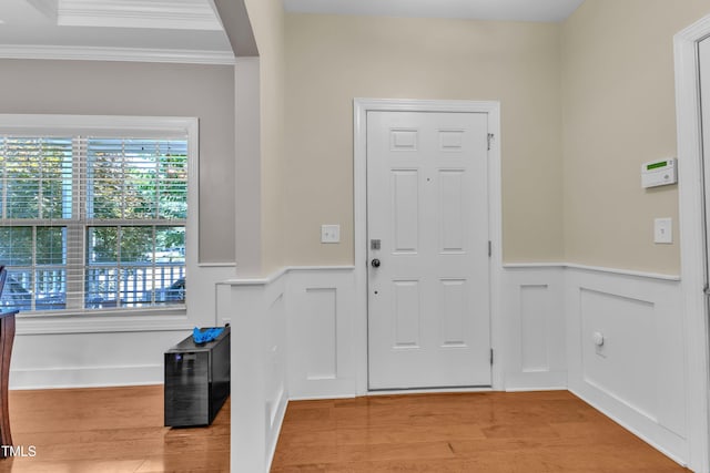 2700 Banks Lake Ct, Fuquay Varina, NC 27526 - foyer entrance featuring ornamental molding, a wainscoted wall, light wood-style flooring, and a decorative wall