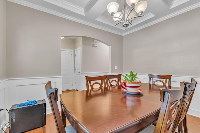 2700 Banks Lake Ct, Fuquay Varina, NC 27526 - dining room featuring a chandelier, crown molding, arched walkways, light wood finished floors, and a wainscoted wall