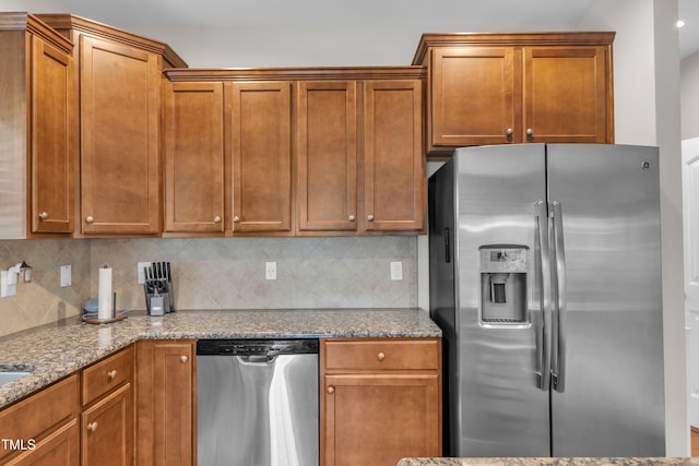 2700 Banks Lake Ct, Fuquay Varina, NC 27526 - kitchen with appliances with stainless steel finishes, backsplash, light stone countertops, and brown cabinets