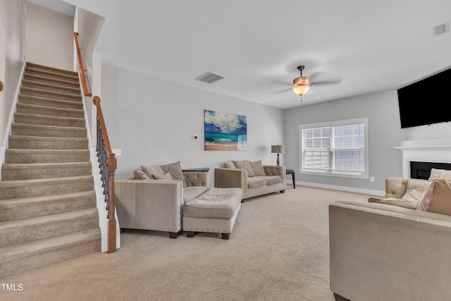 2700 Banks Lake Ct, Fuquay Varina, NC 27526 - living room with a ceiling fan, stairway, light carpet, and a fireplace