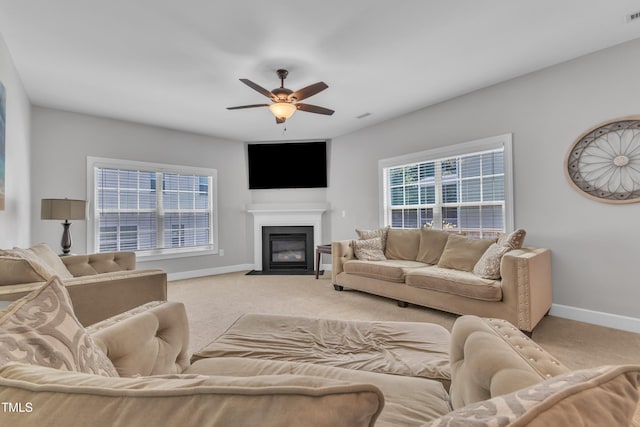 2700 Banks Lake Ct, Fuquay Varina, NC 27526 - living room featuring light colored carpet, a ceiling fan, and a fireplace with flush hearth
