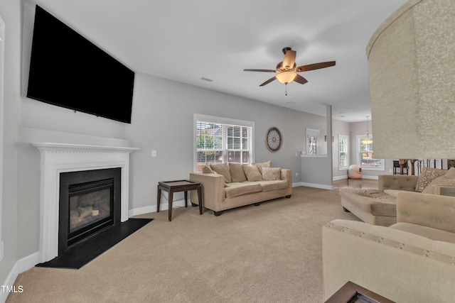 2700 Banks Lake Ct, Fuquay Varina, NC 27526 - living room featuring a glass covered fireplace, carpet flooring, and ceiling fan