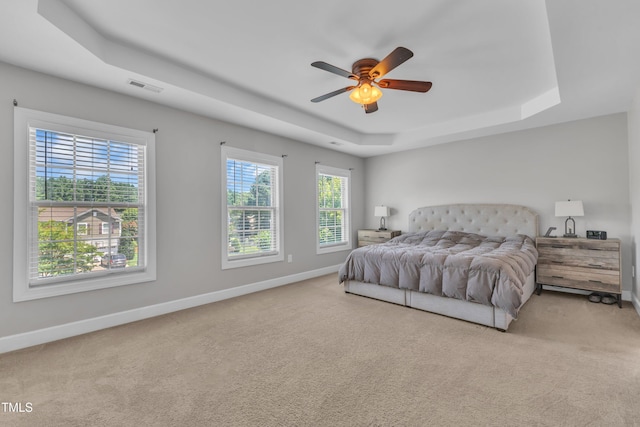 2700 Banks Lake Ct, Fuquay Varina, NC 27526 - carpeted bedroom featuring a tray ceiling and a ceiling fan
