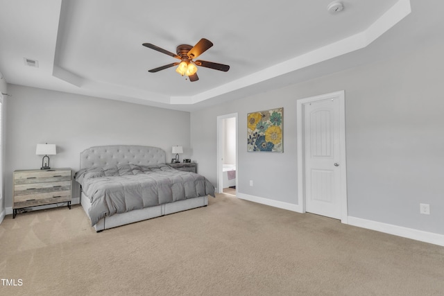 2700 Banks Lake Ct, Fuquay Varina, NC 27526 - bedroom with a tray ceiling, carpet, a ceiling fan, and connected bathroom