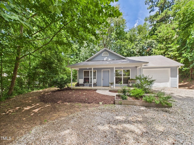 422 Revere Rd, Hillsborough, NC 27278 - view of front of home featuring covered porch, an attached garage, and gravel driveway
