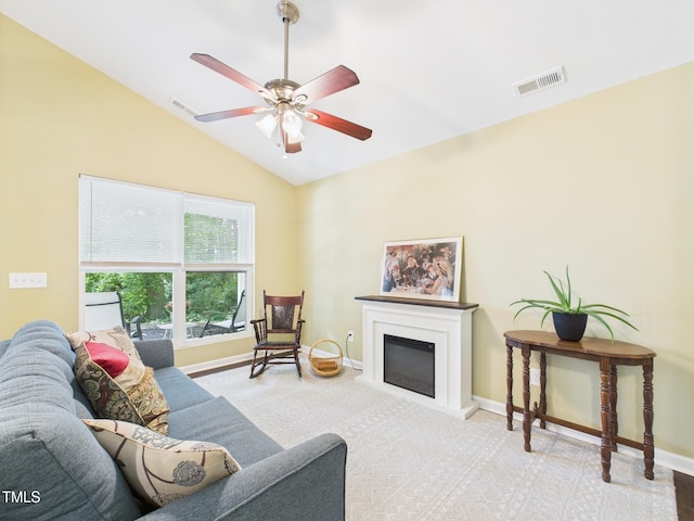 422 Revere Rd, Hillsborough, NC 27278 - carpeted living room with vaulted ceiling, a ceiling fan, and a glass covered fireplace