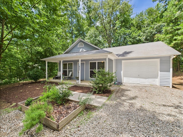 422 Revere Rd, Hillsborough, NC 27278 - view of front of home with a garage, a porch, gravel driveway, and roof with shingles