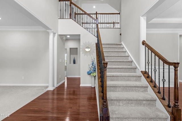 316 Hilliard Forest Dr, Cary, NC 27519 - stairway with crown molding, wood finished floors, decorative columns, recessed lighting, and a towering ceiling