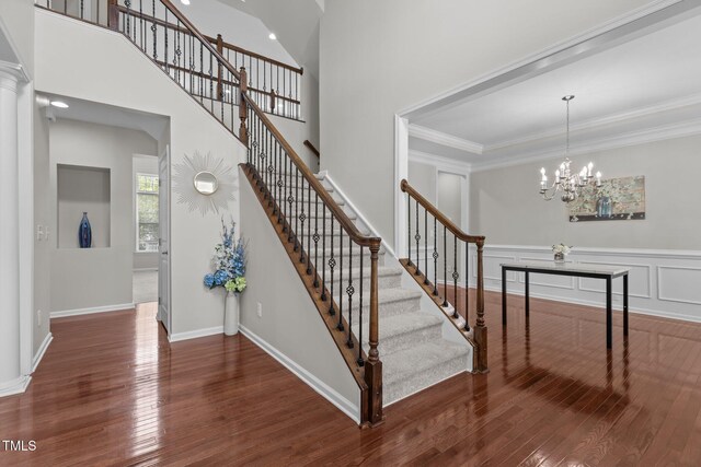 316 Hilliard Forest Dr, Cary, NC 27519 - stairs with hardwood / wood-style flooring, a chandelier, and crown molding