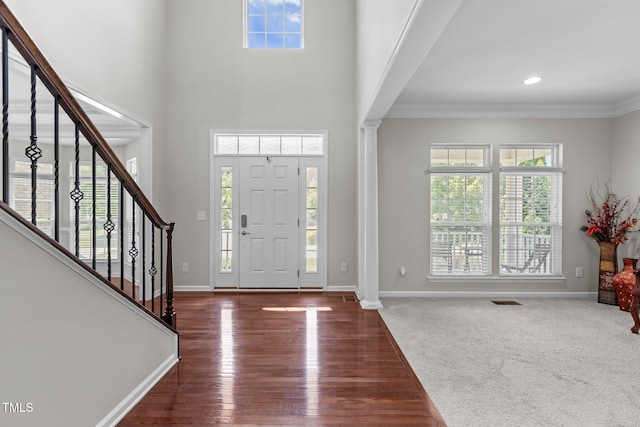 316 Hilliard Forest Dr, Cary, NC 27519 - entryway featuring decorative columns, plenty of natural light, stairway, ornamental molding, and wood finished floors